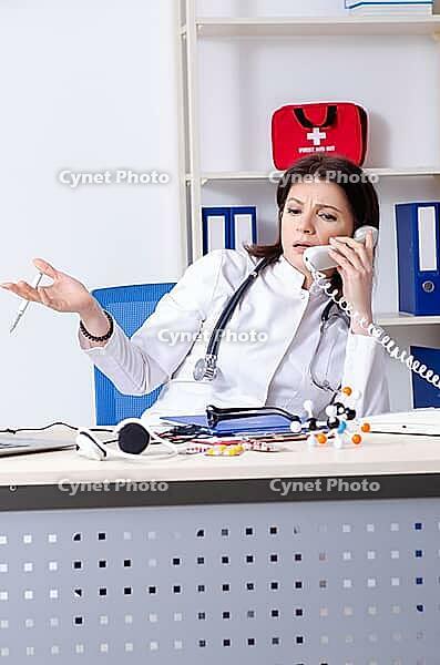 Middle aged doctor in telemedicine concept [IBR125344277]