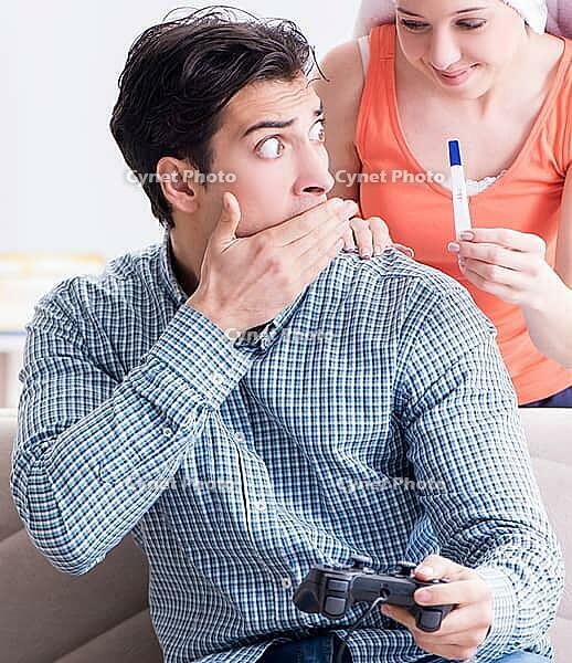The woman and man are looking at a pregnancy test [IBR125344279]