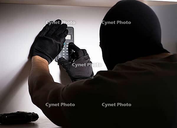 The burglar with a balaclava at the crime scene [IBR113372468]