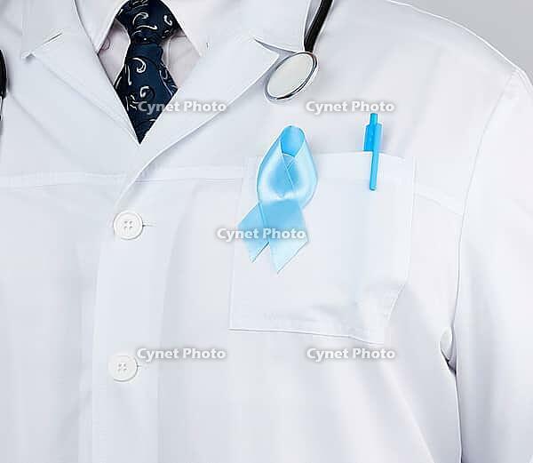 On the pocket pinned a blue ribbon in the shape of a loop, symbol of the fight and treatment of prostate cancer [IBR125363562]