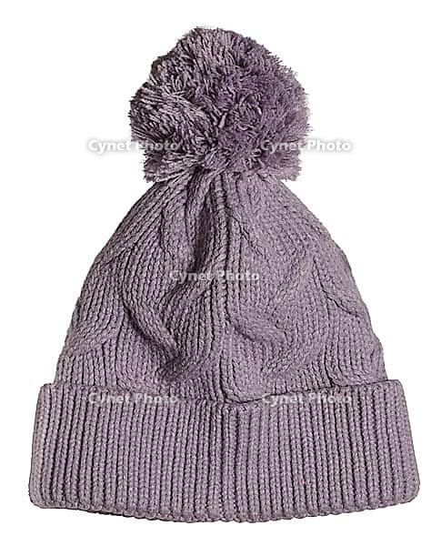 Knitted woolen pink hat with pompom on isolated background, close up [IBR125363586]
