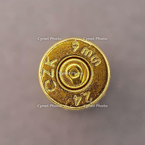 9 mm brass sleeve with spent bullet - detail of the head stamp [IBR125363597]
