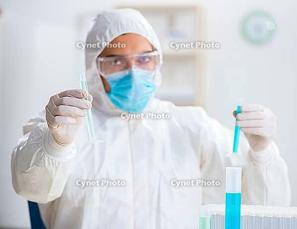 The young chemist works in a chemical laboratory [IBR125363606]