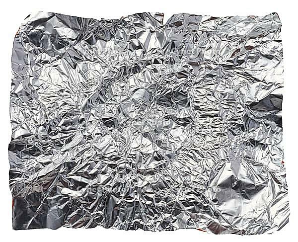 Crumpled piece of gray foil on a white isolated background, close up [IBR125363627]