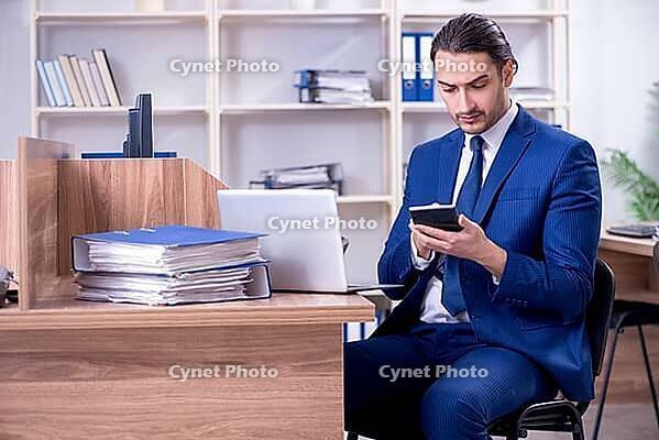 Young handsome businessman working in office [IBR125382580]