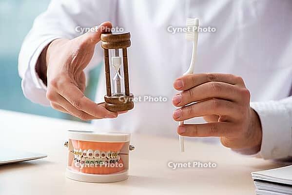 Male doctor, stomatologist working in clinic [IBR125382584]
