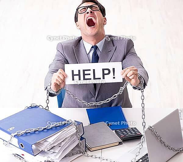 Busy employee is chained to his desk [IBR125382590]