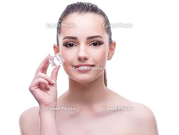 The woman in the beauty concept puts on makeup [IBR125382599]
