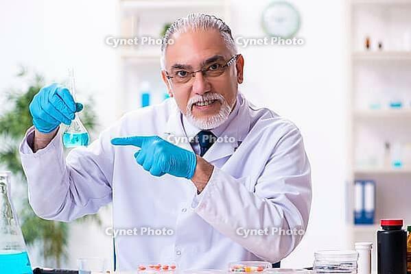 Old chemist working in laboratory [IBR125382610]
