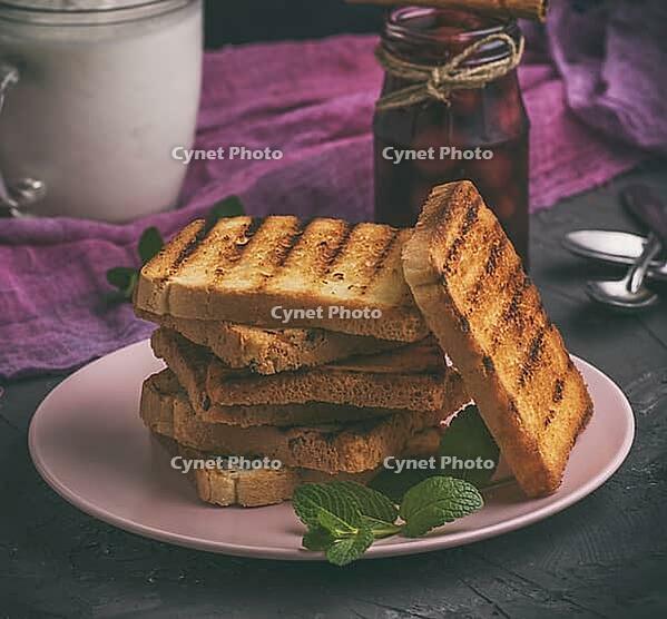 Fried square pieces of white wheat flour in a ceramic pink plate, vintage toning [IBR125382622]