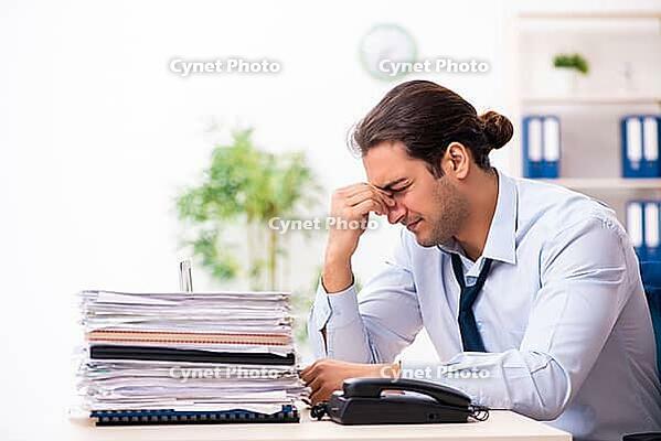 Young employee dissatisfied with excessive work [IBR125382623]