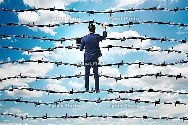Businessman in barbed wire concept [IBR125382636]