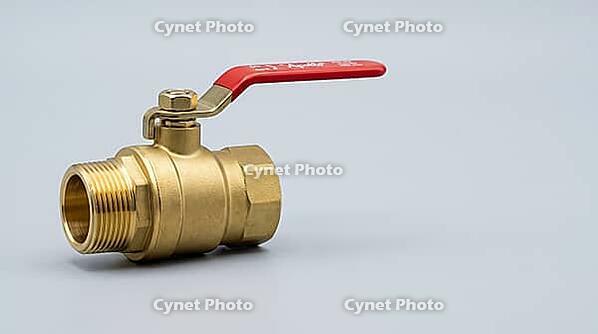Ordinary yellow brass shutoff valve with a smooth golden exterior, hiding invisible zinc leaching from dezincification, studio shot, AI generated [IBR125395916]
