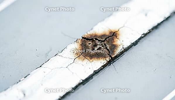 Silver solar cell contact finger actively darkening and oxidizing at a microcrack site, extreme macro photography of a real-time chemical transformation, AI generated [IBR125395934]