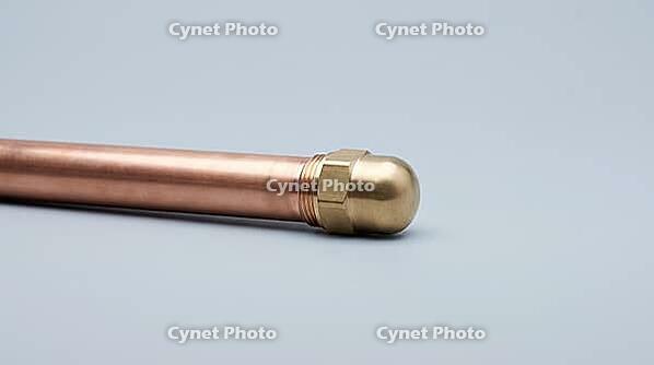 A capped copper pipe section with a smooth metal end cap and even exterior surface, no visible marks or moisture, on a plain grey studio background, close-up product shot, AI generated [IBR125395939]