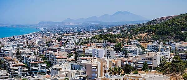 Panoramic view of the Greek city of Rethymno from a height on the island of Crete Greece. Residential buildings and the Aegean sea. [IBR125405073]