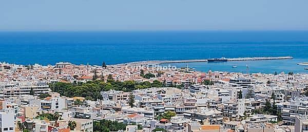 Panoramic view of the Greek city of Rethymno from a height on the island of Crete Greece. Residential buildings and the Aegean sea. [IBR125405087]