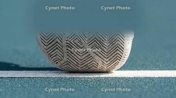 Close-up of a white tennis shoe's herringbone tread sole pressed against a hard court surface along a painted white baseline, bright natural daylight, sports footwork concept, AI generated [IBR125407438]