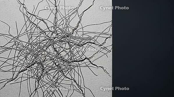 Interlocking network of metallic lithium dendrite filaments and crack lines on ceramic block surface, dark background, clinical lighting, studio shot, AI generated [IBR125407473]
