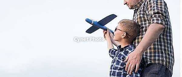 Dad and son have fun in the field and play with an airplane. Father's Day concept [IBR125411068]