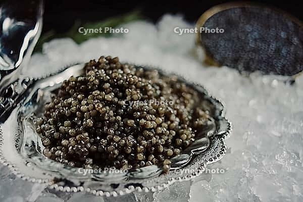 Black caviar served on the table. Exquisite delicacy of black sturgeon caviar [IBR125411077]