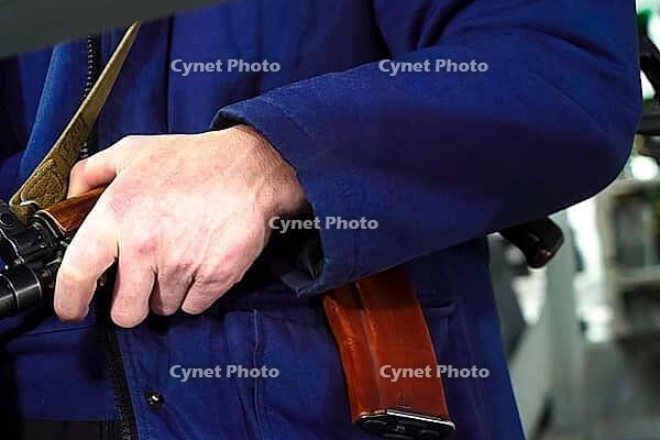 A security guard's hand on a Kalashnikov. Armed departmental guards [IBR125411129]