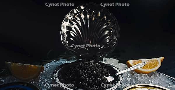 Black caviar served on the table. Exquisite delicacy of black sturgeon caviar [IBR125411145]