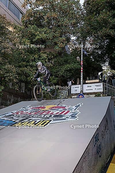 05 September 2026, A mountain biker catches air off a wooden ramp during Red Bull Cerro Abajo in Stuttgart, Germany [IBR113394901]