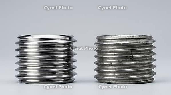 Side by side comparison of bright unworn machined steel thread and duller worn thread with fine crack, pale grey background, industrial macro photography, fatigue wear comparison, AI generated [IBR125414176]