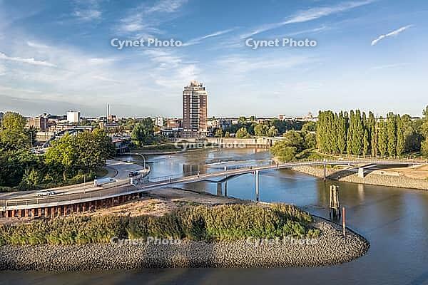 Aerial view of the curved Entenwerder Bridge across the entrance to Oberhafen with a view of Rothenburgsort and Entenwerder Elbpark, Hamburg, Germany [IBR113394948]