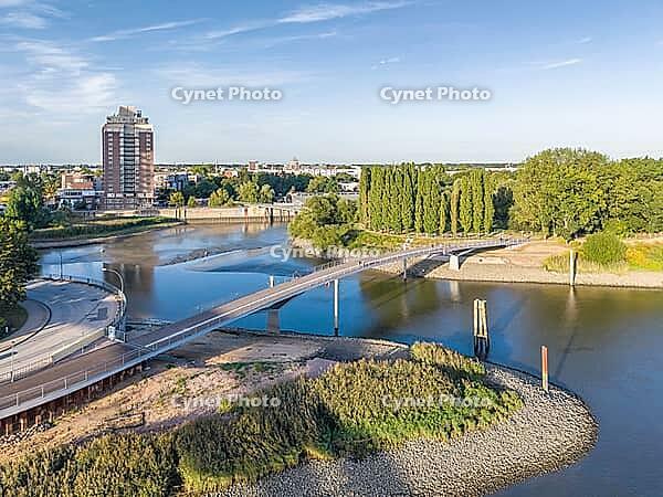 Aerial view of the curved Entenwerder Bridge across the entrance to Oberhafen with a view of Rothenburgsort and Entenwerder Elbpark, Hamburg, Germany [IBR113394949]