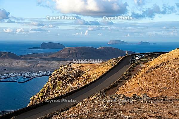 Road on the coast, back island of La Graciosa, Mirador del Porrito viewpoint at sunset, Lanzarote, Canary Islands, Spain [IBR125414218]