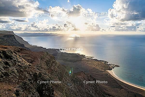 Steep cliffs on the coast with sea, Mirador del Porrito viewpoint at sunset, Lanzarote, Canary Islands, Spain [IBR125414219]