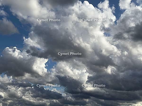 Large cloud field dense cloud cover large wind-driven white cluster clouds Cumulus Stratocumulus with gray underside under blue sky, Germany [IBR125414245]