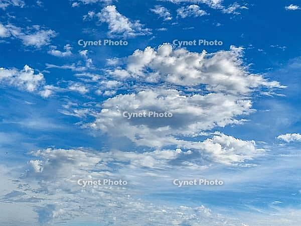 White cluster clouds Cumulus in various shapes above small altocumulus middle cumulus below back Stratocumulus under blue sky, Germany [IBR125414248]