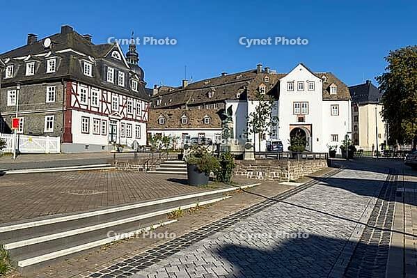 View of over Goetheplatz with old historic residential building half-timbered house in the background in the background 16th century gate house of Berleburg Palace facing the city side, Bad Berleburg, North Rhine-Westphalia, Germany [IBR125414254]