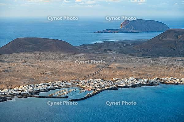 View of the sea and the island of La Graciosa with the village of Caleta de Sebo, at sunset, Lanzarote, Canary Islands, Spain [IBR125414266]