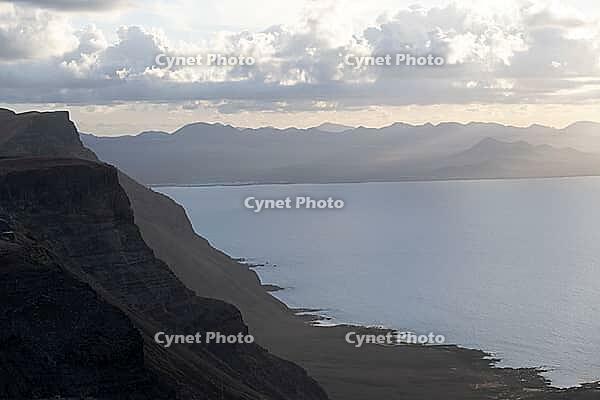 Steep cliffs on the coast with sea, Mirador del Porrito viewpoint at sunset, Lanzarote, Canary Islands, Spain [IBR125414273]