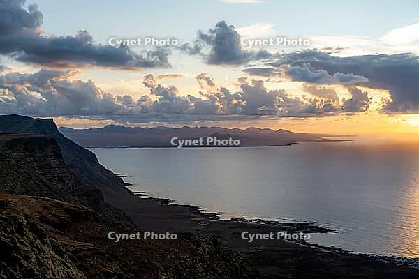 Steep cliffs on the coast with sea, Mirador del Porrito viewpoint at sunset, Lanzarote, Canary Islands, Spain [IBR125414274]