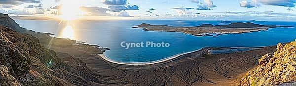 View of steep cliffs to sea and the island of La Graciosa, Mirador del Porrito viewpoint at sunset, Lanzarote, Canary Islands, Spain [IBR125414285]