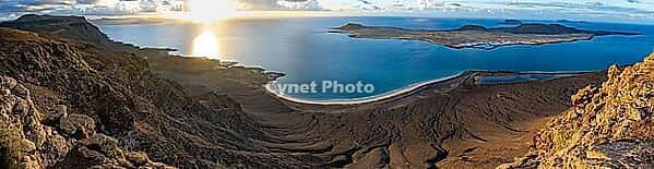 View of steep cliffs to sea and the island of La Graciosa, Mirador del Porrito viewpoint at sunset, Lanzarote, Canary Islands, Spain [IBR125414287]