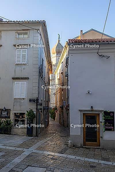 Narrow alley in the old town, in the back the cathedral tower, Krk, Krk island, Croatia [IBR125415364]