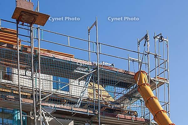 Scaffolding with downpipe and dumpster during construction work to renovate an old building, Bremen, Germany [IBR125415382]