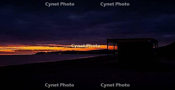 A photo of the sunset on the beautiful beach of Posada, Sardinia [IBR125415396]