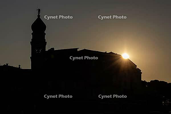 Sunrise behind the bell tower of the Assumption Cathedral with baroque onion dome and trumpet blowing angel, old town of Krk, island of Krk, Croatia [IBR125415397]