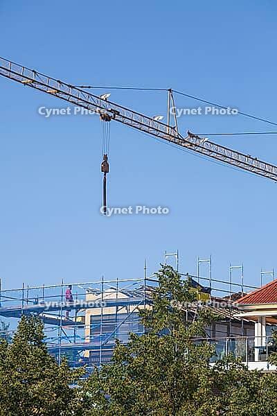 Shell of a residential building with scaffolding, construction crane and blue safety net, residential construction, Emden, East Frisia, Lower Saxony, Germany [IBR125415407]