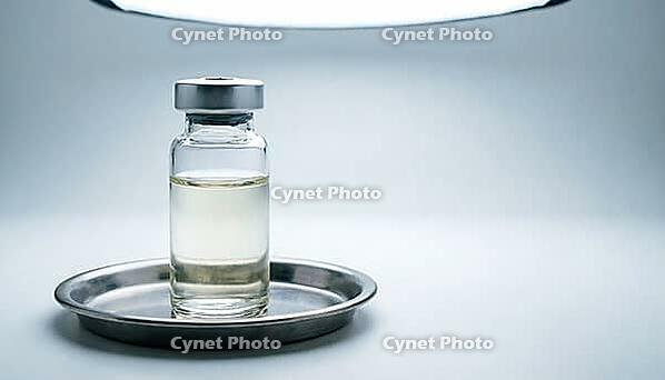 Clear glass sensor calibration reference vial with colorless liquid on a stainless steel tray, clinical laboratory studio lighting, analytical instrumentation photography, AI generated [IBR125421233]