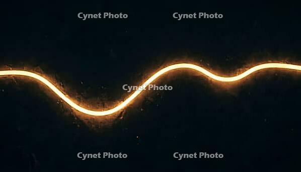 Abstract glowing amber infrared absorption spectrum curve with subtle dips on a dark background, no readable labels, spectroscopy data visualization concept, AI generated [IBR125421271]