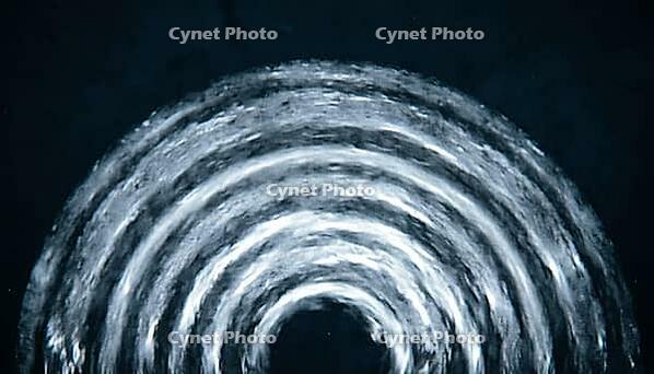 Abstract fan-shaped grey blue concentric wave pattern representing echocardiogram ultrasound imaging, dark background, cardiac monitoring concept, clinical macro photography, AI generated [IBR125421272]