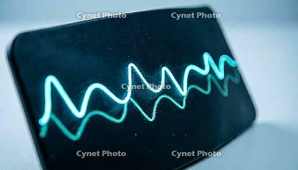 Abstract glowing cyan and teal vital signs waveform display with no readable numbers, dark curved surface, cardiac monitoring concept, clinical macro photography, AI generated [IBR125421283]